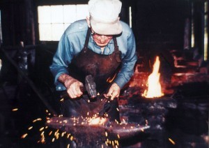 The blacksmith working away in the shop at Lang Pioneer Village (photo: Lang Pioneer Village)