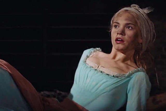 Lily James as the orphan Ella who, dirtied with cinders, is given the demeaning nickname "Cinderella" by her wicked stepmother and stepsisters