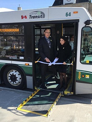Peterborough Mayor Daryl Bennett and Minister Monsef cutting a ribbon on one of the low-entry, fully accessible buses (photo: Maryam Monsef / Facebook)