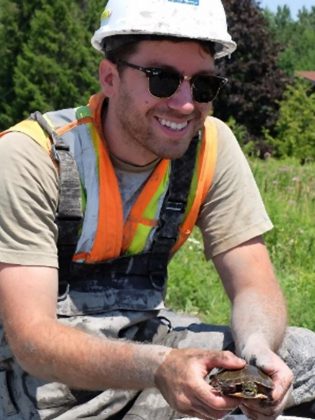 Biologist Dan Stuart holds a painted turtle