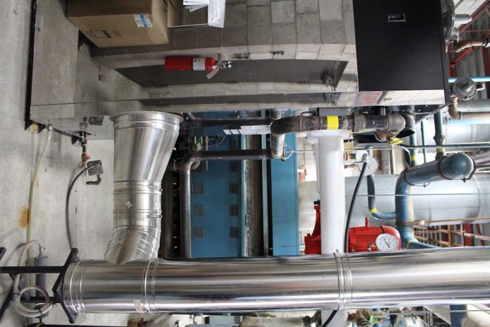 Two new energy efficient boilers, one pictured in the foreground, replace six of the older units (blue unit pictured in background) that were installed when the mall first opened in 1975.