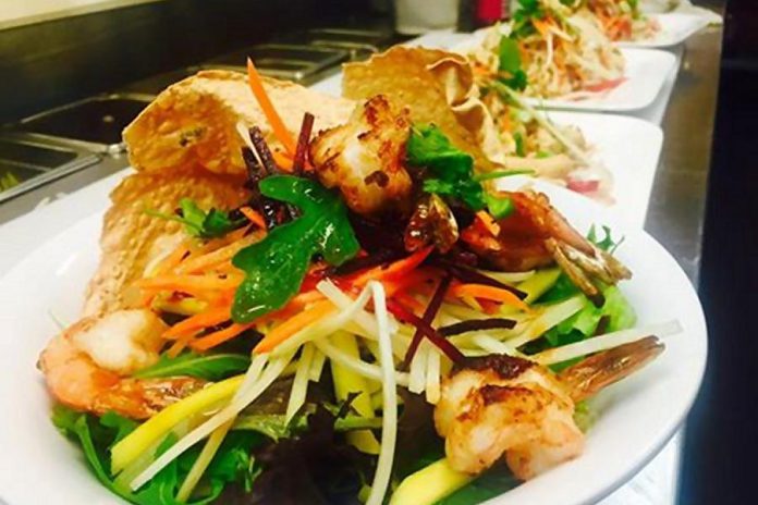 Mixed greens topped with mango, papaya, carrots and grilled shrimp (Photo: Karma Phuntshok)