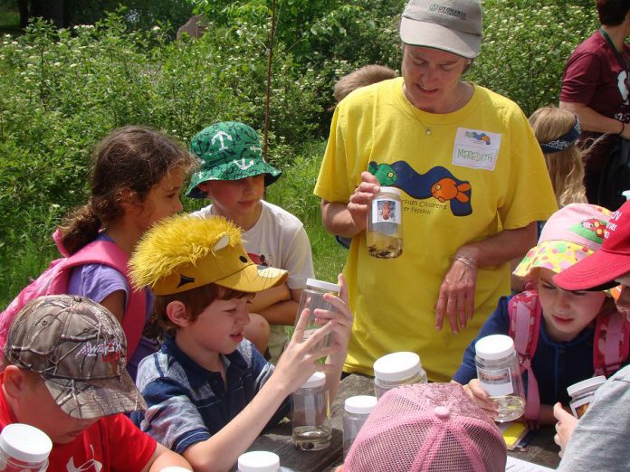 As the 2015 Peterborough Children's Water Festival, Meredith from Otonabee Conservation shows children the many invertebrates that live in local water systems and how these critters can be indicators of water quality in our lakes, rivers, and streams.  WOW activities consist of water science experiments, such as separating sediment from water samples or looking at insect larvae that indicate a stream's water quality. (Photo: GreenUP)