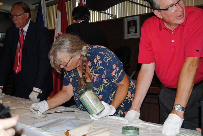 Lang Pioneer Village conservator Basia Baklinski examines the contents of the time capsule.