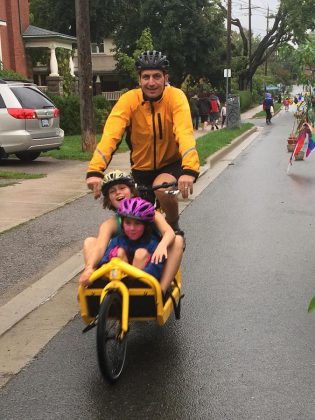 John Hauser, owner of a Bullitt cargo bike, takes two children for a ride at the King Street Pulse Pop-Up on September 17. The cargo bike can be adapted with tubs, lockable boxes, canopies, flat boards, or child seats, depending on personal needs.