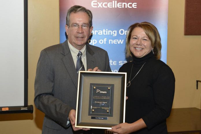 Cindy Hope receiving the 2011 Premier's Award for Agri-Food Innovation Excellence from Jeff Leal, MPP Peterborough and Minister of Agriculture, Food and Rural Affairs. Cindy and Kevin Hope received the award for their business achievement with Cross Wind Farm, their dairy goat farm. (Photo: Ministry of Agriculture, Food and Rural Affairs)