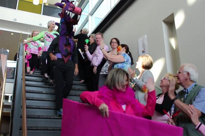 Staff at Peterborough Regional Health Centre cheer on Peterborough's Dragon Boat Festival organizers and volunteers (and the dragon mascot, inhabitated by Billy Thornton) as they arrive at the hospital with the cheque  (photo: Impact Communications / PRHC Foundation)