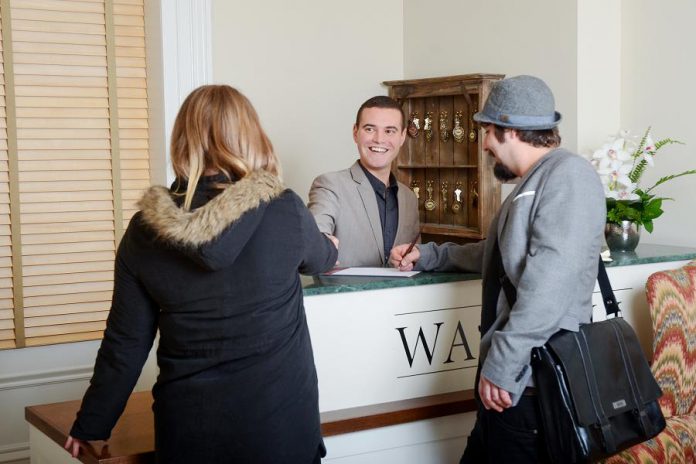 Manager Cameron Hughes with satsified customers at The Waddell, a boutique hotel in Port Hope (photo courtesy of RTO8)