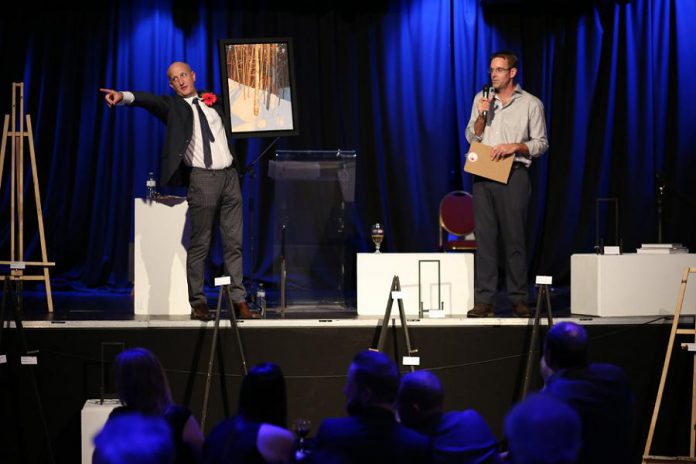 Auctioneers Matt Stimpson and Dave Miller take enthusiastic bids on the last work of the evening: a painting by Lakefield resident Peter Rotter (photo courtesy of Matt and Steph)