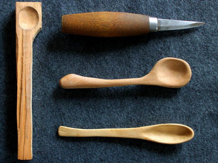 Finished spoons, a carving knife, and a "spoon blank" ready to be carved. The spoons shown here smaller than the ones that will be carved during the November 19 workshop at Curated. (Photo courtesy of David Fry)