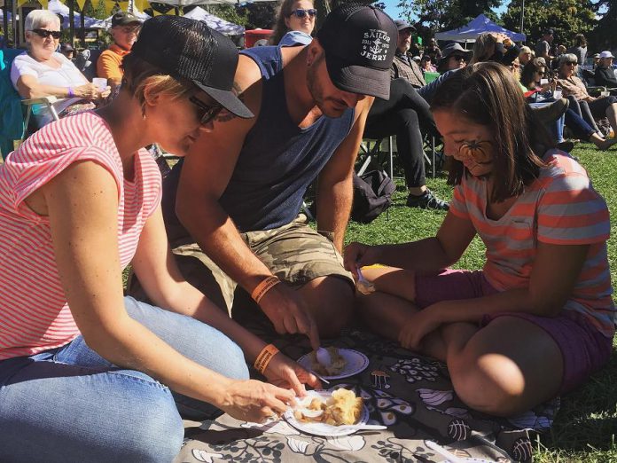 The Cultivate festival in Port Hope was launched in 2015 using Partnership Allocation funding and drew 1,300 attendees in its inaugural year. At this year's festival, a family from Toronto enjoys a locally produced pie while listening to entertainment on the bandshell stage at Memorial Park. (Photo: Cultivate)