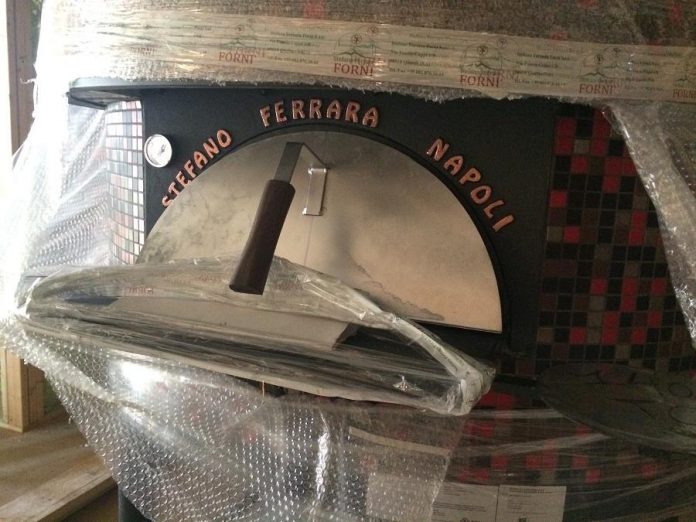 A closer look at the wood-fired pizza oven, custom made in Italy. (Photo: Eva Fisher)