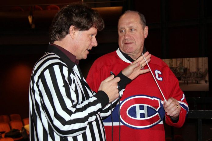 Peterborough Symphony Orchestra music director and conductor Michael Newnham jokingly calls Bob Gainey on a "baton penalty" at the Showplace Performance Centre stage