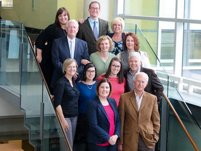 PRHC Foundation President & CEO Lesley Heighway (front left) is joined by PRHC President & CEO Dr. Peter McLaughin (front right) and PRHC Foundation staff and board representatives for a photo in celebration of PRHC Foundation being designated a high performer by the Association for Healthcare Philanthropy.