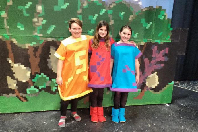 Three of the young actors performing in "The Reluctant Dragon" at Peterborough Theatre Guild (photo: Sam Tweedle / kawarthaNOW)