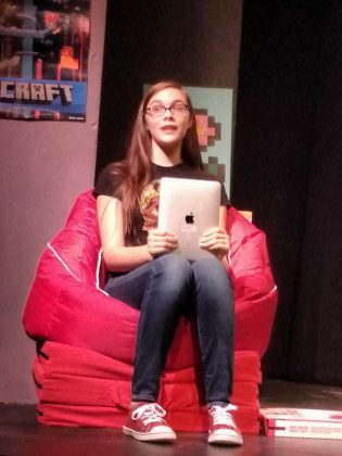Aimee Gordon as Gamer Girl during a dress rehearsal for "The Reluctant Dragon". Her character plays the video game in which the play's action takes place and she addresses the audience.  (Photo: Sam Tweedle / kawarthaNOW)