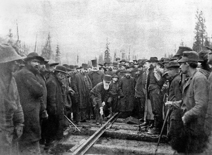 Donald Alexander Smith (Lord Strathcona) driving the last spike of the Canadian Pacific Railway at Craigellachie, British Columbia, on November 7, 1885, with Fleming standing behind him (photo: Wikipedia)