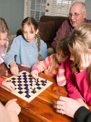 Family literacy isn't just about reading together. It's also about engaging together in other family learning activities such as playing board games.