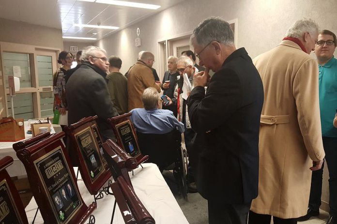 Junior Achievement board chair Paul Ayotte examines the plaques of last year's inductees into the Junior Achievement Business Hall of Fame (photo: Jeannine Taylor / kawarthaNOW)