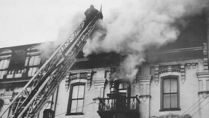 A firefighter battles a fire on the third floor of The Pig's Ear in 1949. The building originally had four storeys, but the fourth storey was seriously damaged by a fire in the 1930s and was never rebuilt.