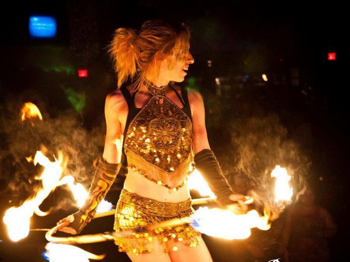 Victoria Wood, of the performing group the Pyroflys, during a fiery performance (photo courtesy of Public Energy)