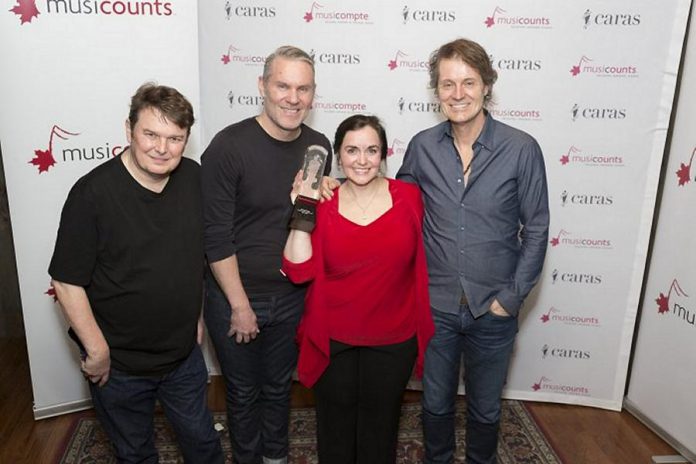 Bazil Donovan, Colin Cripps, and Jim Cuddy of Blue Rodeo, which sponsored this year's award, with winner Dianne Winmill  (photo: Barry Roden / musiCounts)