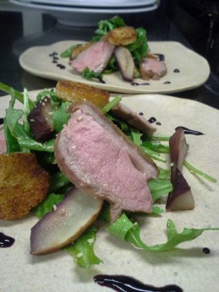 Chef Jay Nutt serves duck breast on fresh greens with poached pears, duck fat croutons, and blueberry gastrique at Mount Julian at Viamede Resort (photo: Jay Nutt)