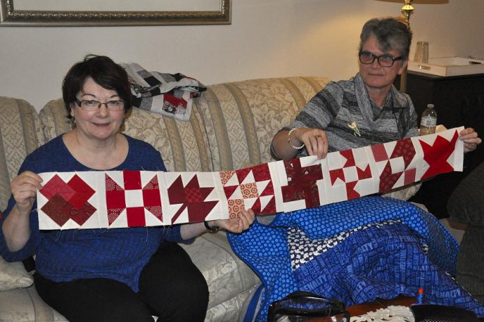 Colleen Carruthers and Debbie Fisico show off a row of the blocks that will make up the 150 Canadian Women quilt. Each block of the king-sized finished quilt is designated for a Canadian woman who has in some way been significant in the country's history.