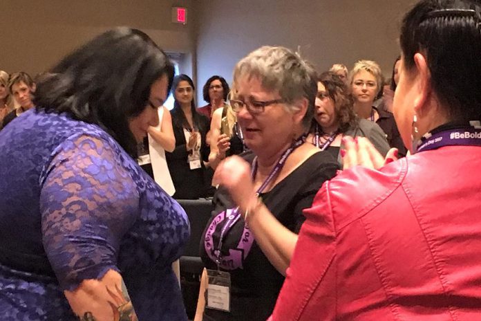Candy Palmater's courage in overcoming adversity touched the hearts of the conference participants. An emotional Louise Racine, who conceived of the idea of a Peterborough conference for International Women's Day, speaks with Candy following her keynote. (Photo: Jeanne Pengelly / kawarthaNOW)