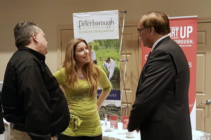 Tiny Greens owner Tina Bromley chats with Peterborough DBIA executive director Terry Guiel and Peterborough Mayor Darryl Bennett at a showcase celebrating successes under the Eastern Ontario Development Program (EODP). Bromely recently won a year-long lease for a downtown Peterborough storefront in the DBIA's Win This Space contest, which was supported with funding from the federal program administered by Community Futures Peterborough. (Photo: Jeannine Taylor / kawarthaNOW)