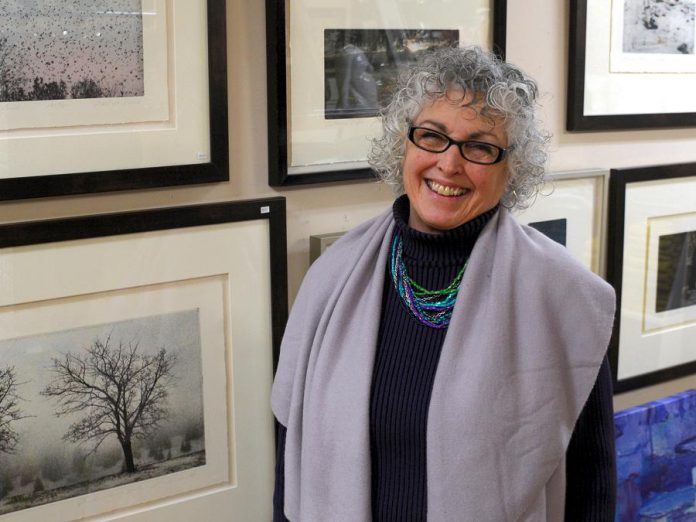 Bonnie McQuarrie of Bethany Hills Interiors stands in front of a wall of etchings by Millbrook-based artist George Raab. Bonnie provides interior design services customized to her clients. "I love helping clients pull together a look that works with their budget, their colours, and their way of thinking." (Photo: Eva Fisher / kawarthaNOW)