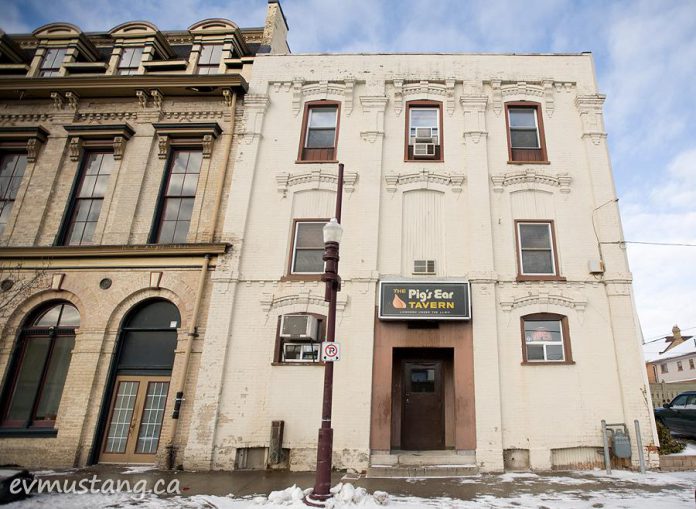 The building at 144 Brock Street, currently housing The Pig's Ear Tavern, was built in the mid 1860s and was originally The Windsor Hotel. It predates the construction of the historically designated Morrow Building, adjoining on the left. Parkview Homes has purchased the property, and the Pig's Ear Tavern will be closing on April 22, 2017 (Photo: Esther Vincent, evmustang.ca)