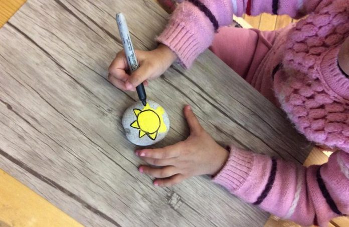 Senior Kindergarten and Grade 1 students, led by teacher Kim Meekin, have painted more than 150 rocks for their Spread the Sunshine project