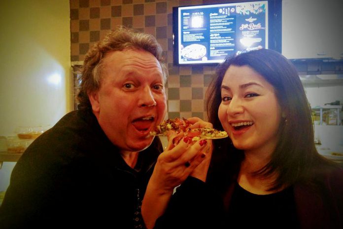 Peterborough's downtown continues to attract new businesses, thanks in part to Terry's efforts. Here he is with Peterborough-Kawartha MP Maryam Monsef enjoying a slice during last month's grand opening of Silk Roots Fusion Cuisine.