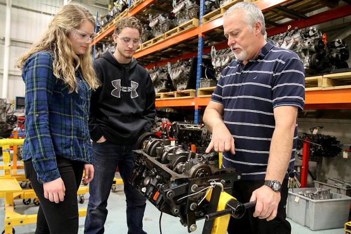 Durham College professor Wayne MacDonald instructs Holy Cross Catholic Secondary School students Cheyenne Snache and Daymeon Robitaille, both of whom are in the automotive course as part of the Ontario Youth Apprenticeship Program.