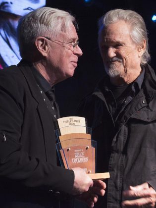 Bruce Cockburn receiving the inaugural Folk Alliance International People's Voice Award in February 2017 from Kris Kristofferson (photo: Andrea Brookhart)