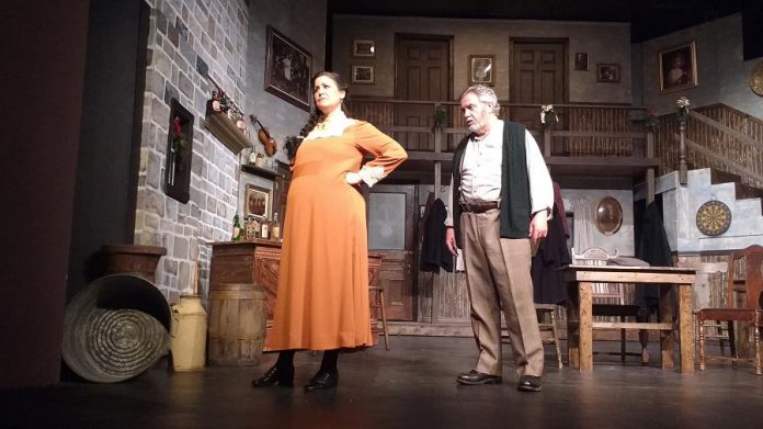 Bridget Foley as Dipna Granville and and Jerry Allen as Fergal Quinn. This photo shows the incredible multi-level set created on the stage of the Peterborough Theatre Guild. (Photo: Sam Tweedle / kawarthaNOW)