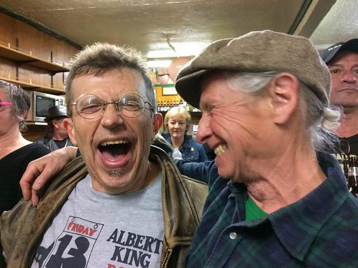 JP Hovercraft, whose band Rezonator hosted the final PMBA Deluxe Blues Jam and who also was celebrating his 65th birthday, enjoys a moment with fellow musician Bobby Watson (photo: Kate Kelly)