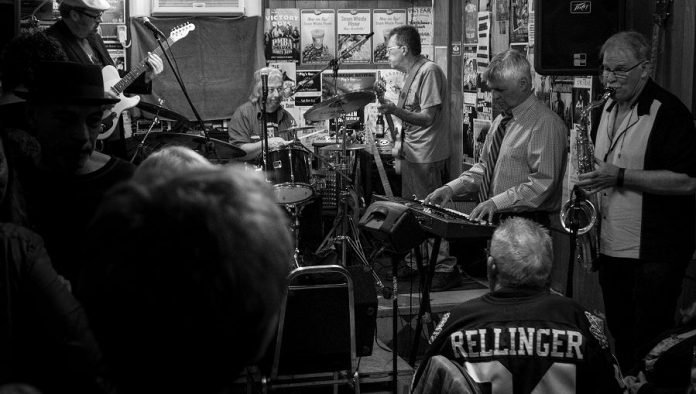 "They're just taking the dance to a new ballroom." Paul Rellinger at the final Deluxe Blues Jam at The Pig's Ear on April 15th. The monthly PMBA fundraiser will now be held at Dr. J's BBQ and Brews. (Photo: SLAB Productions)