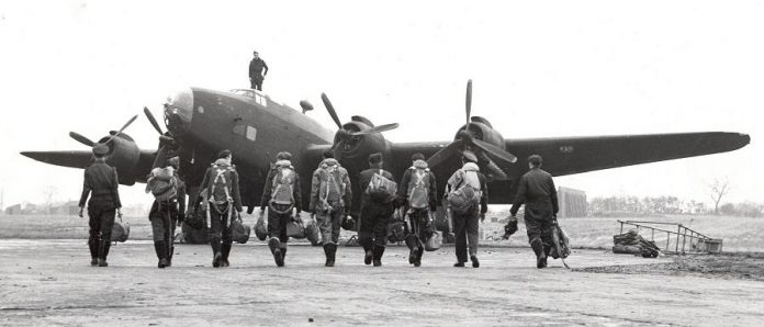 RCAF No. 6 Group aircrew walking to their Handley Page Halifax bomber in October 1944. (Photo: Department of National Defence PL-3394) 
