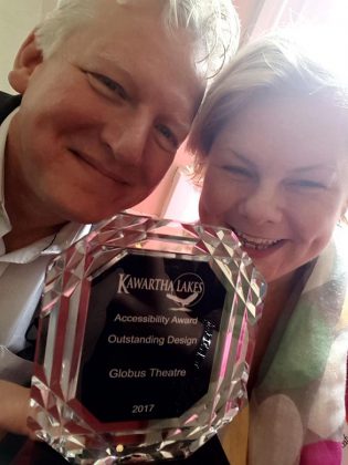 Globus Theatre eliminated barriers to accessibility at the Lakeview Arts Barn in 2016 with the installation of two accessible washrooms and a push-button automatic door opener. Here James and Sarah pose with their accessibility award from the City of Kawartha Lakes for Outstanding Design. (Photo: Globus Theatre)