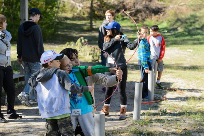 Families practice archery at the James Fund Neuroblastoma Family Retreat. Since 2007, the annual Nexicom James Fund Golf Classic has raised more than $350,000 to support this cornerstone event. (Photo: Chris Bumstead / Jennifer Gillespie)