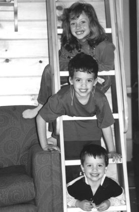 Rebecca, James (wearing hearing aids as a result of chemotherapy killing his auditory hair cells), and Ben Birrell. Researcher Katie Brown will begin work at the University of British Columbia this fall to study the impact on siblings who've specifically lost a brother or sister to neuroblastoma or brain tumours. (Photo: The Birrell family)