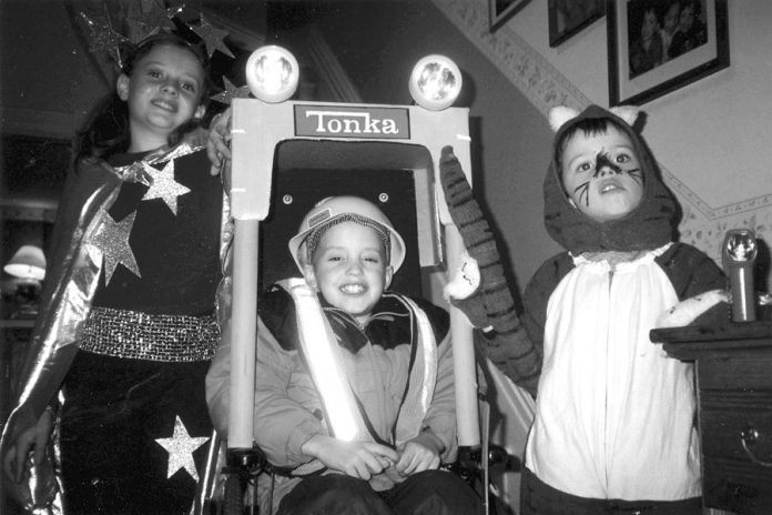 Siblings Rebecca, James, and Ben Birrell as children at Halloween. James was too ill to leave his wheelchair for trick or treating so a friend converted his wheelchair into this forklift costume.  (Photo: The Birrell family)