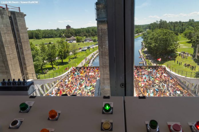 A view from the control room as both chambers are at equal elevation, and participants raise their paddles to sing O Canada and Happpy Birthday. (Photo: Linda McIlwain / kawarthaNOW)