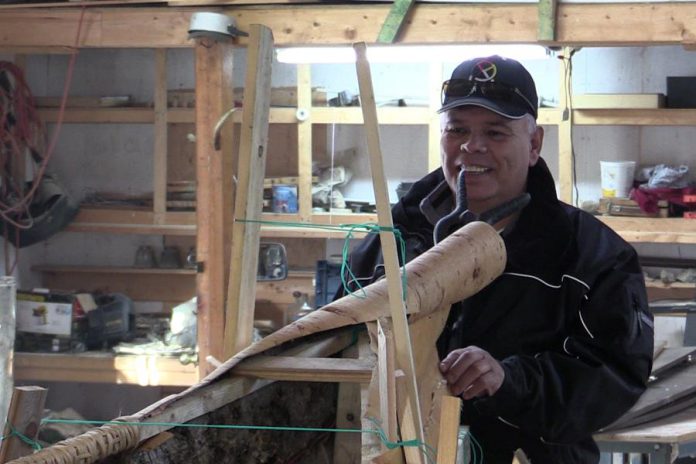 Chief Mi'sel Joe of the Miawpukek First Nation working on the canoe. (Photo: Miawpukek First Nation)