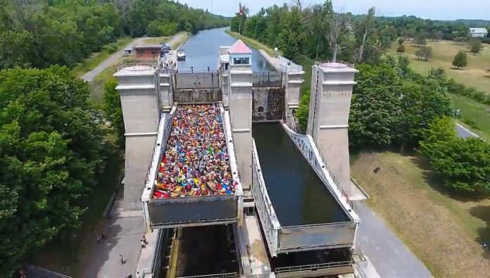 A screenshot from the 2016 drone video showing the 138 canoes and kayaks being lifted in one chamber of the Peterborough Lift Lock. This year, both lock chambers will be filled with 150 paddlecraft for a total of 300.