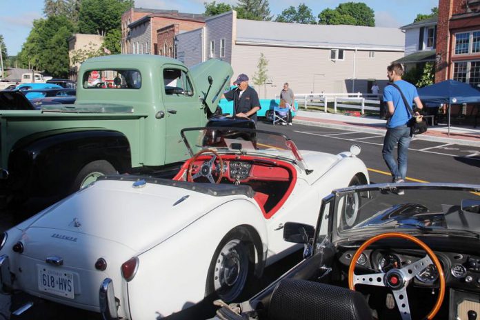 Organizer Andy Stevenson jokes that, while the men are gathered around the cars talking about engine specs, the women sneak off for some shopping in downtown Millbrook. (Photo courtesy of Andy Stevenson)
