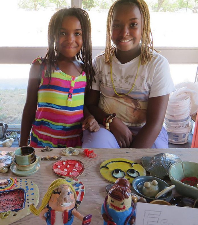 Two young artisans pose with their clay creations. Ceramic arts is proving to be a very focused, relaxing and meditative kind of craft. Subconsciously, children are directing their focus and energy towards building something. (Photo:  Kawartha Potters' Guild)