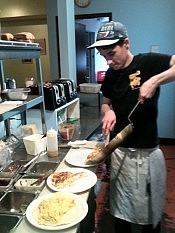 Employee Ben Tyne preparing omelettes, which The Planet serves throughout the day (photo: Carol Lawless)